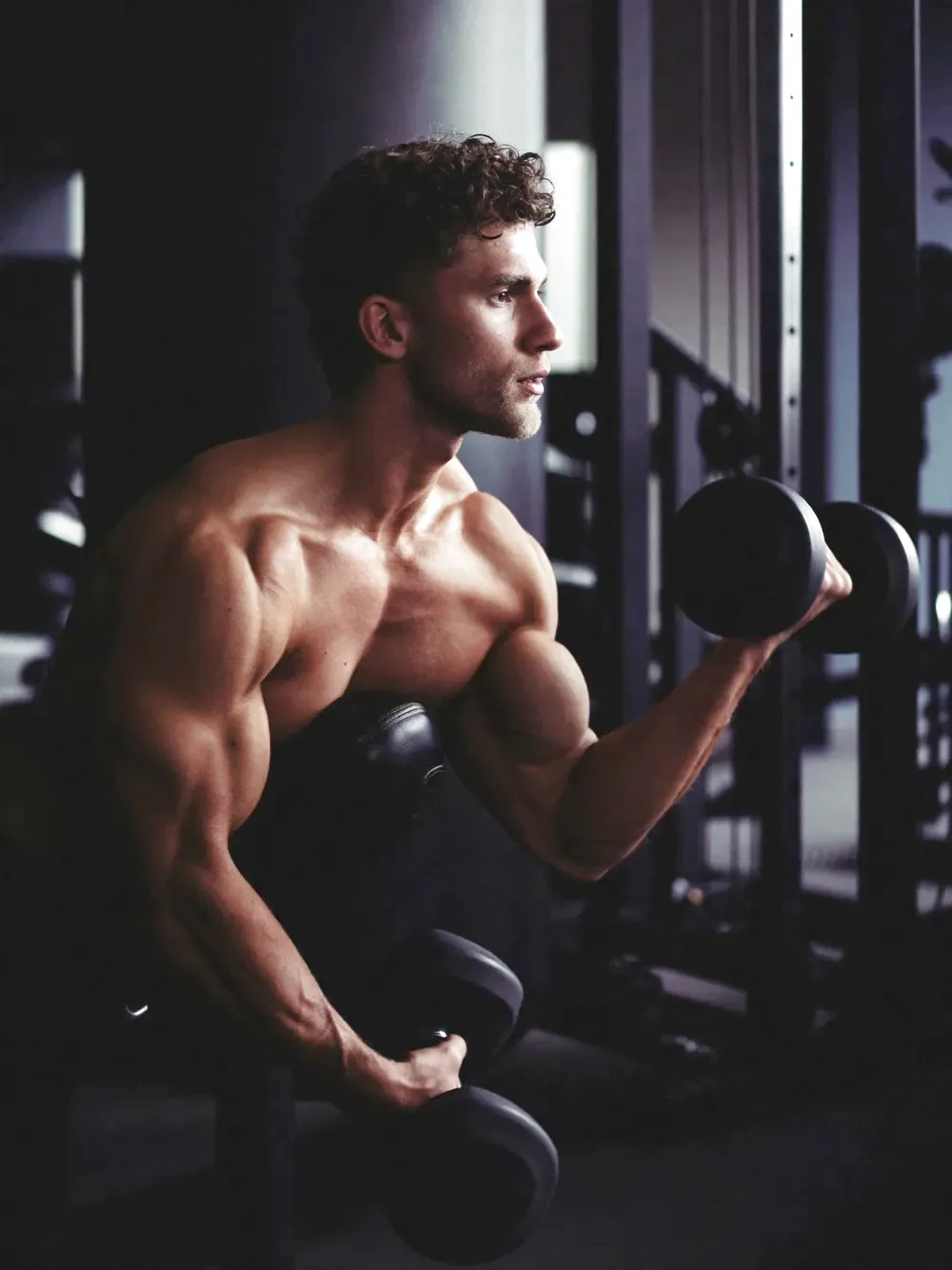 A person doing a dumbbell curl in a modern gym